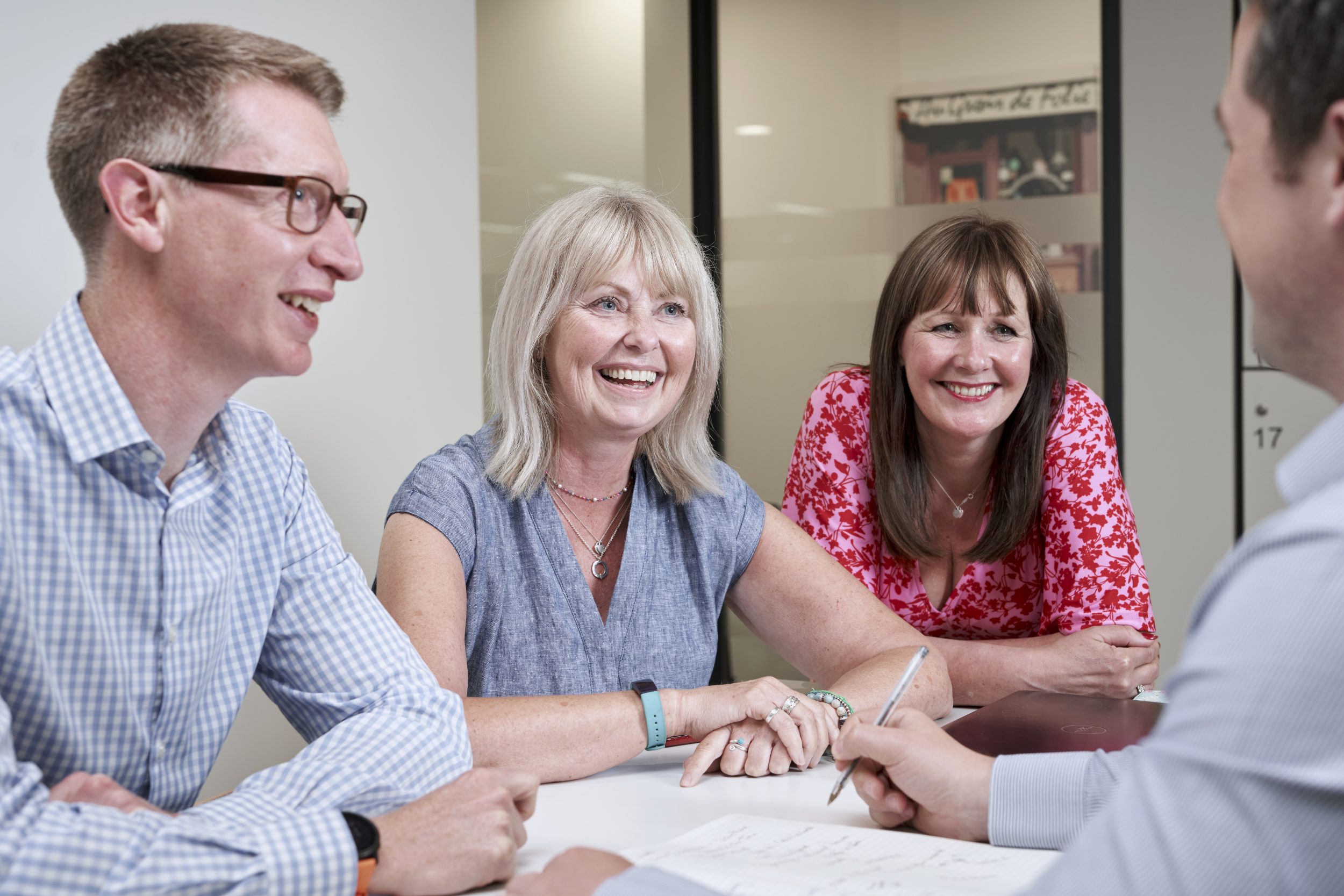 The team at Barkers discuss a Building Construction Project around a table at their office in Braintree, Essex.