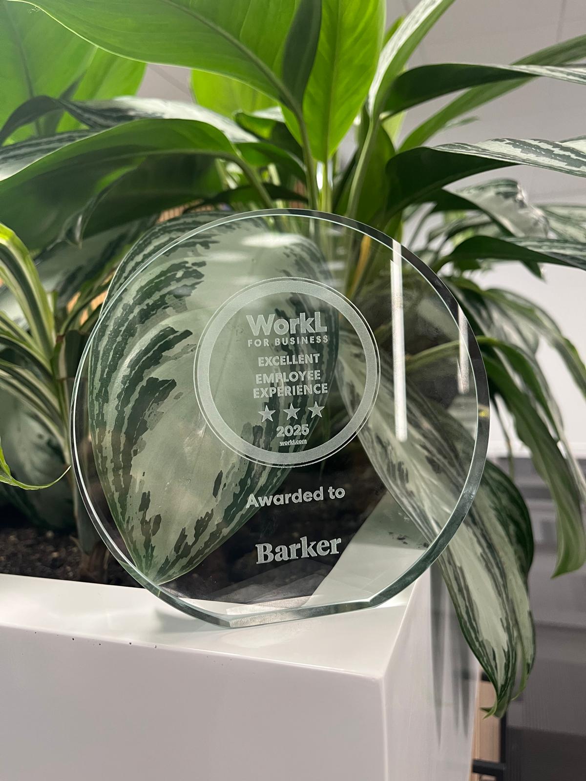 Glass WorkL Employee Experience Winner award infront of plants